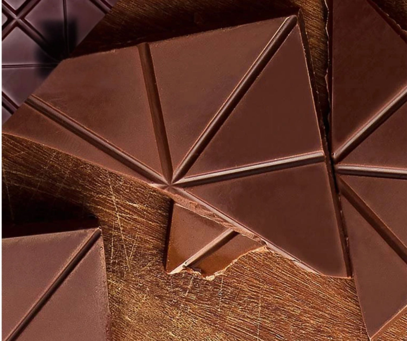 Cacaosuyo Piura Milk 50% broken chocolate bar, geometric triangular segments, warm brown texture, Piura Blanco cacao Peru